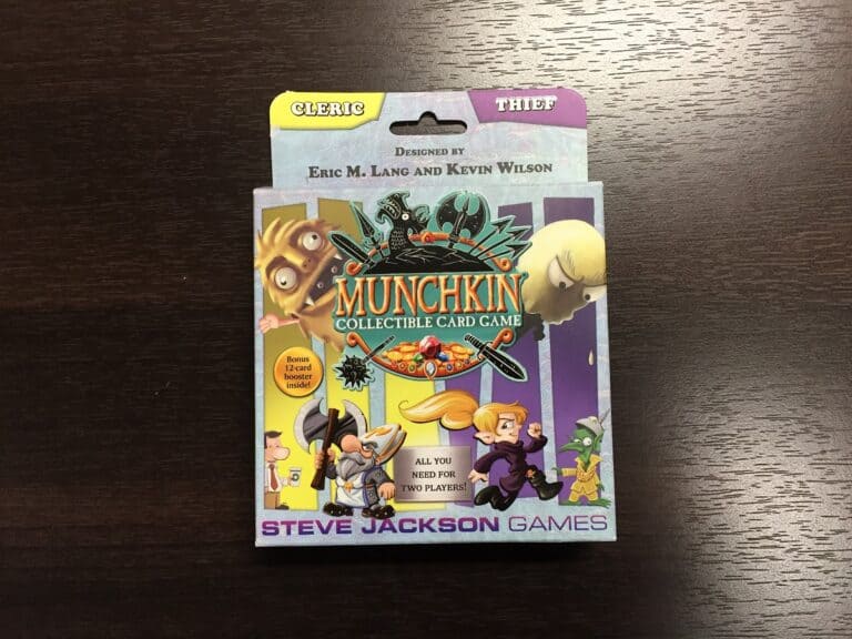 The Munchkin CCG box bursts with vibrant artwork of cartoon characters, designed by Eric M. Lang and Kevin Wilson. Tabs labeled "Cleric" and "Thief" peek at the top, promising a thrilling adventure. Perfect for collectors, it’s sure to catch the eye of any TGN Review reader!