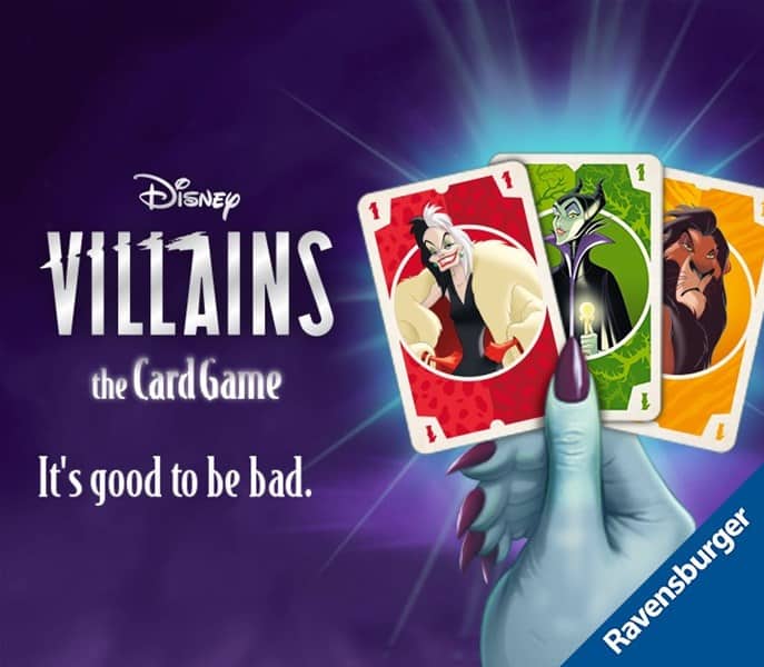 A promotional image for Ravensburger's Disney Villains Card Game. A hand grasps three villainous playing cards with the tagline "It's good to be bad" against a dark, mystic background.