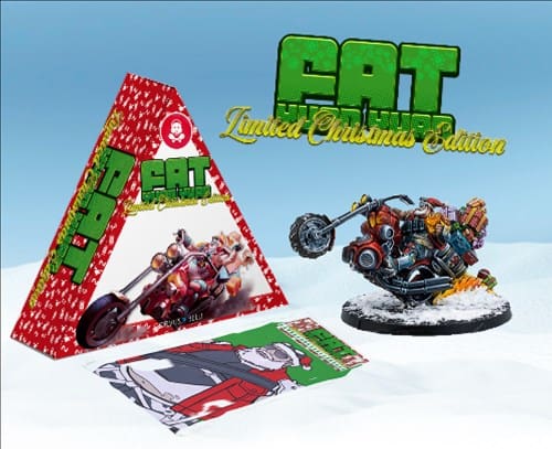 Behold the limited Holiday Edition of a motorcycle-themed collectible. Nestled in a triangular box with festive graphics, it showcases a December scene: a motorcycle model on glistening snow alongside a holiday-themed card. The background captures a snowy landscape under a clear sky.