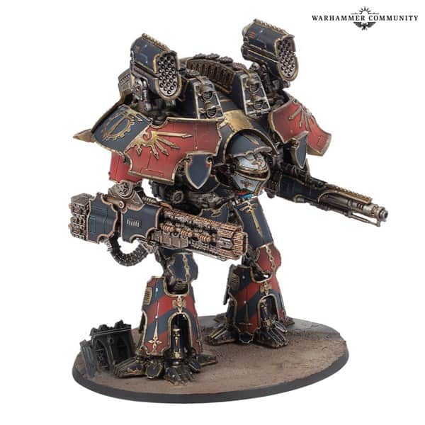This detailed miniature model of a Warhammer Titan from Games Workshop features intricate armor with a red and blue color scheme and gold embellishments. Standing on a circular base, it wields Volkite weapons in each arm, showcasing a mix of mechanical and gothic design elements reminiscent of Adeptus Titanicus.