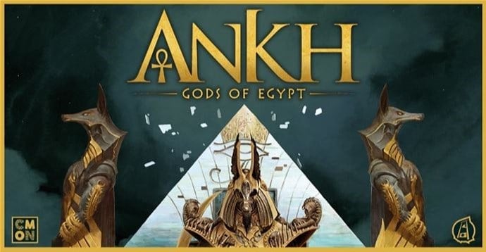 Cover art for "Ankh: Gods of Egypt" by CMON features two stylized Egyptian jackal-headed figures flanking a central pyramid. The title, "Ankh Board Game," is prominently displayed at the top in radiant gold lettering.