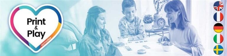 A family sits at a table playing a Print and Play Games board game. On the left, a heart-shaped logo reads "Print & Play." To the right, various national flags like UK, US, France, and Germany indicate different language options. This free game offers global fun for all ages!
