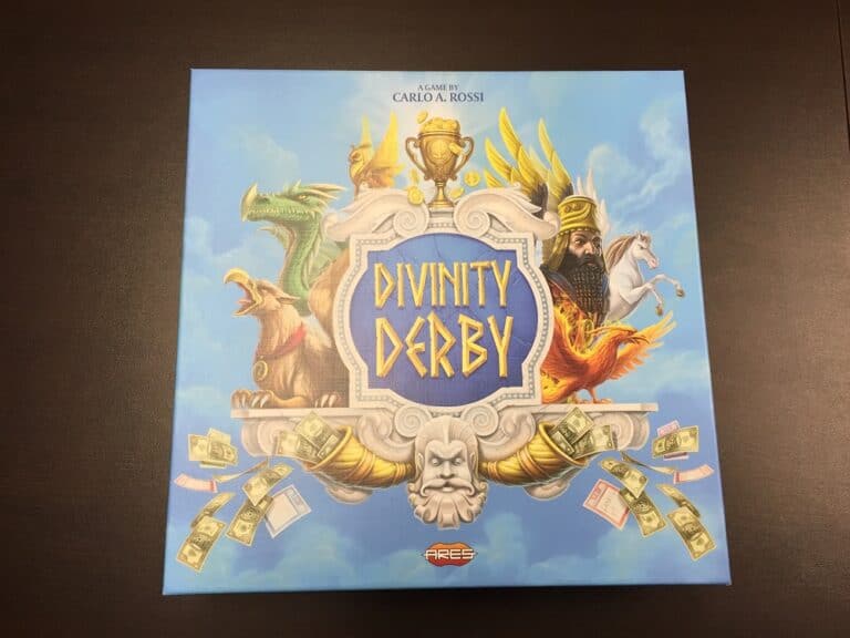 The box cover of Ares Games' "Divinity Derby" showcases mythical creatures like a dragon, eagle, and phoenix beneath a crown-wearing figure. The design boasts a central shield with decorative elements and flying money around the sides, as noted in the TGN Review.