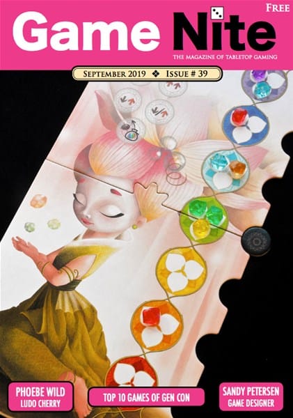 Cover of Game Nite Magazine, Issue 39, September 2019. Available now, it features an artistic image of a fairy-like character with colorful circular patterns. Headlines mention "Phoebe Wild Ludo Cherry," "Top 10 Games of Gen Con," and "Sandy Petersen Game Designer.