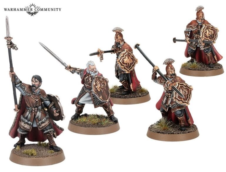Miniature figures of fantasy warriors in intricate armor, reminiscent of Lord of the Rings figures, wield swords and spears. Detailed shields and capes complete their look as they stand on small bases with moss-like textures, capturing the essence of Games Workshop's craftsmanship.
