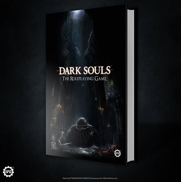 A dark and atmospheric book cover for "Dark Souls: The Roleplaying Game" by Steamforged. It features a cloaked figure sitting in a dimly lit stone chamber with candles and dark shadows, evoking a mysterious and ominous mood—perfect for fans eagerly anticipating previews of the Dark Souls RPG.