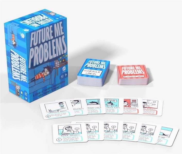 Box and card game set titled "Future Me Problems," crafted by Mattel Creations. The image showcases a vibrant blue game box, a stack of blue "Schedule Cards," red cards, and illustrated cards featuring playful cartoon characters and witty text, bringing this engaging card game to life.
