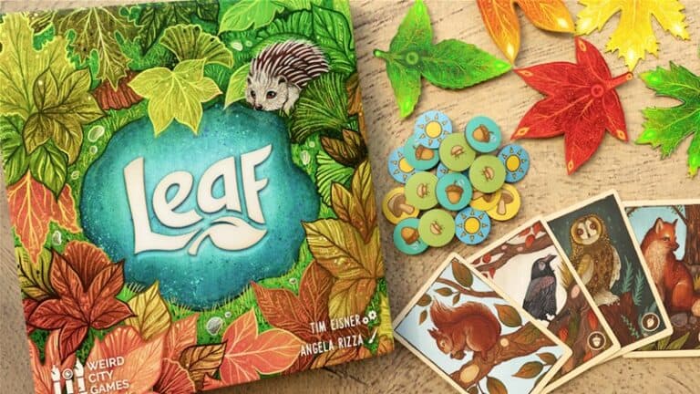 The image showcases "Leaf," a board game by Weird City Games, celebrated on Kickstarter. The vibrant box displays a hedgehog surrounded by autumn leaves. Game components include leaf-shaped pieces, circular tokens adorned with icons, and beautifully illustrated animal cards.