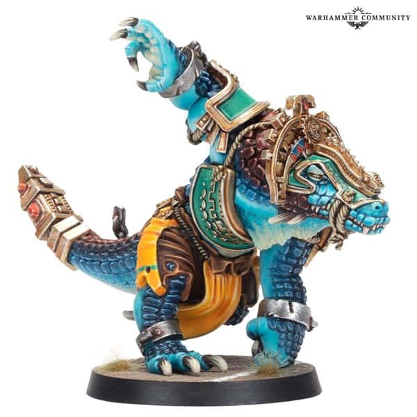 A detailed miniature model from Games Workshop of a blue-scaled, reptilian creature wearing ornate golden armor and accessories. It boasts a muscular build with a raised arm, standing on a small circular base, showcasing vibrant colors and intricate designs reminiscent of Blood Bowl champions.