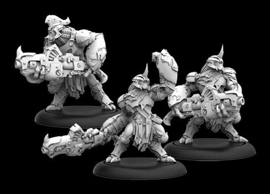 Three intricately detailed Warmachine miniature figures, crafted by Privateer Press, wield large weapons and wear heavy armor on circular bases. The figures boast a futuristic, mechanical appearance with helmets and elaborate gear against a solid black background.