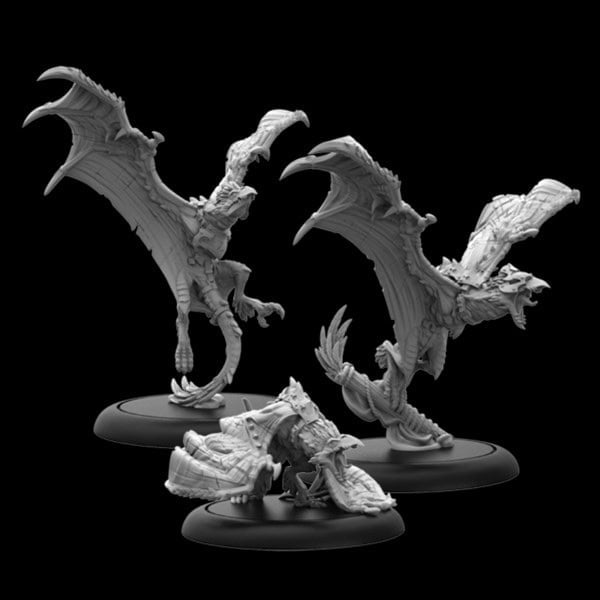 Three detailed dragon miniatures with fierce expressions and outstretched wings are positioned on black bases against a dark background. Like Orgoth units from Warmachine, these sculptures display intricate scales and muscular forms, suggesting movement and power.