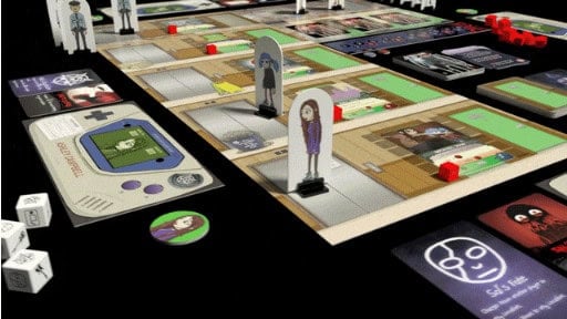 A colorful tabletop game with character standees, cards, and dice on a dark surface. The game board features illustrated rooms and pathways, reminiscent of Sally Face's eerie adventures, with various tokens and cards scattered around the playing area.