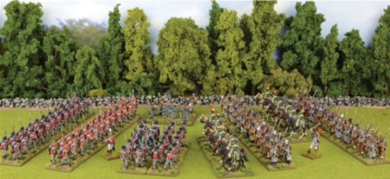 A diorama inspired by Warlord Games' Black Powder releases showcases a historical battle scene, with miniature soldiers in formation. On the left, red-coated soldiers stand in order, facing off against blue-coated foes on the right, amidst a backdrop of trees and a stone wall.