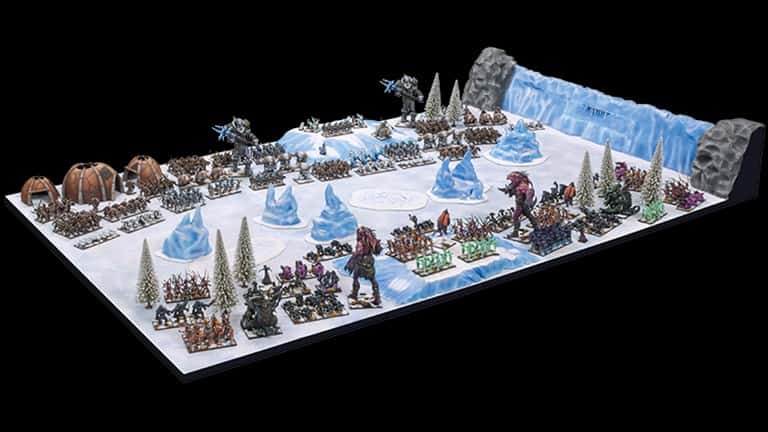 In this immersive tabletop game, reminiscent of Kings of War, players navigate a snowy landscape with miniature armies and icy figures. The board boasts detailed, wintry themes and strategic piece positioning, inviting tactical play inspired by the epic scale of Ambush Week.