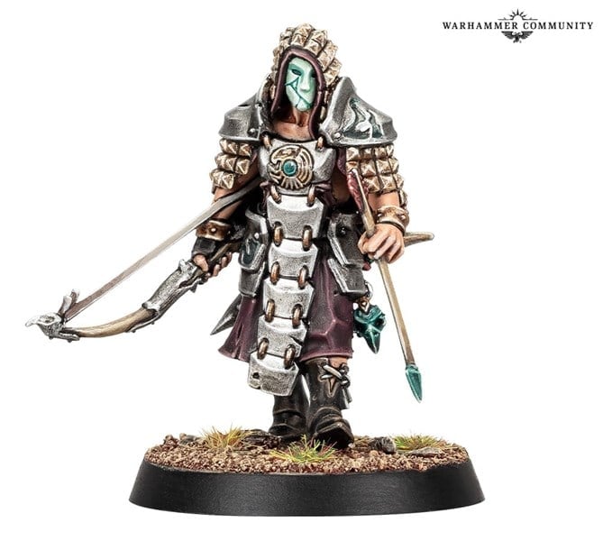 A February Exclusive Mini from Games Workshop, this Warhammer figure showcases an armored warrior with a hood, mask, and bow. The spiked shoulder pads and metal-detailed belt add flair, while the base is adorned with small tufts of grass.