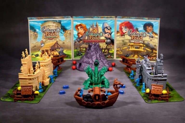 A tabletop game setup showcases the thrilling "Catapult Feud" board game with two opposing castle structures, each armed with small catapults and pieces. Central to the scene is a majestic green dragon on a boat. Three vibrant game boxes flank the background, reminiscent of an animated series.