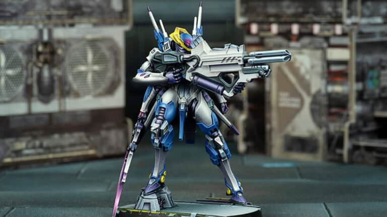 This futuristic robot miniature, crafted from high-quality plastic resin, is painted in shades of blue, white, and purple. It stands on a base with a large gun and sleek, angular design. The background evokes a blurred industrial setting reminiscent of Corvus Belli's renowned craftsmanship.