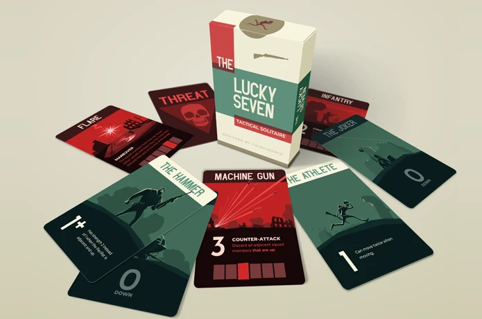 Box of "The Lucky Seven" tactical solitaire card game, a hit on Indiegogo, surrounded by various cards like "Machine Gun," "The Hammer," and "Infantry," all elegantly displayed in a fan-like arrangement on a plain surface.