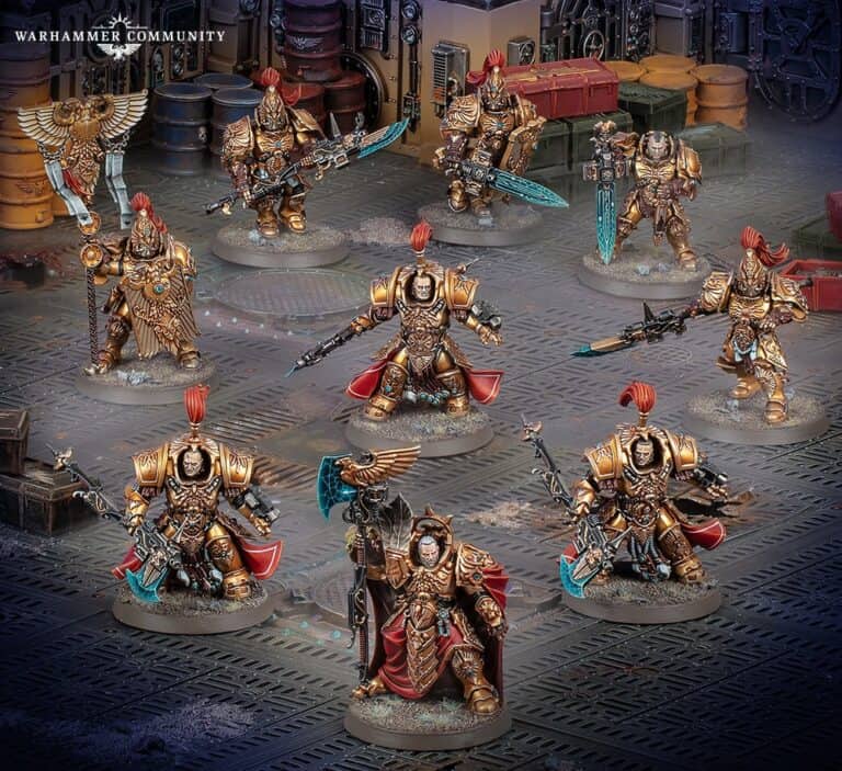 Miniature figures of armored warriors in gold and red are displayed on a textured surface, reminiscent of Warhammer 40k's epic tales. Each holds a unique weapon, such as swords and lances. The intricate details highlight their sci-fi fantasy design amidst a backdrop of industrial crates and barrels.
