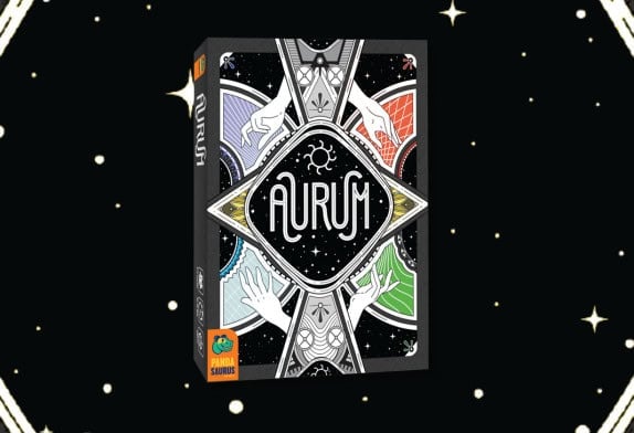 The image showcases the box of the card game "Aurum" by PandaSaurus Games. The box design flaunts an intricate illustration of hands with a triangular, mystical theme, perfectly capturing the allure and strategy typical of a trick-taking game set against a starry black background.