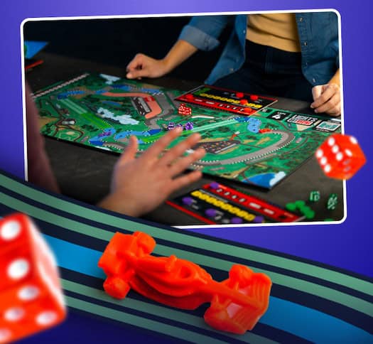 Two people immerse themselves in a colorful board game called Lights Out Racing, featuring a racetrack, dice, and an F1-inspired red car piece. The engaging game includes elements for tracking progress and score. In the foreground, a large red dice complements the vibrant blue backdrop.