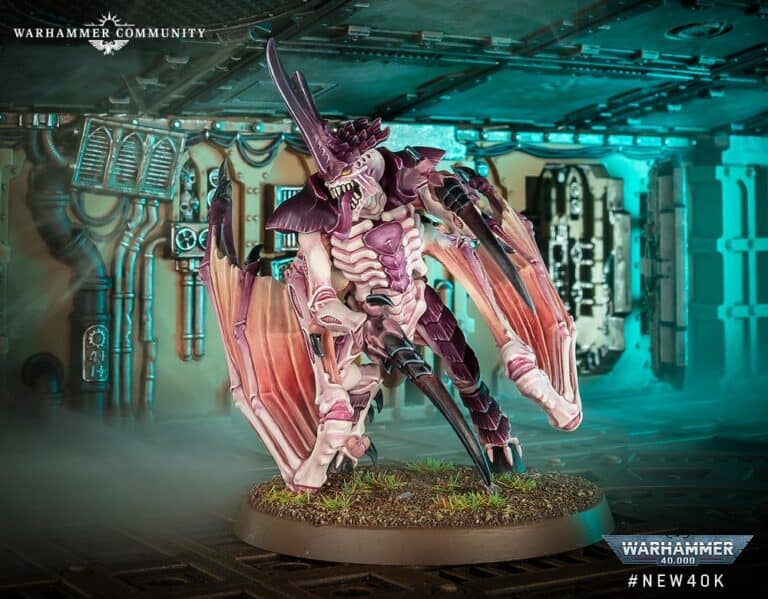 A detailed miniature model of a Winged Tyranid Prime, with pink and purple hues, stands on a base mimicking terrain. It features wings and menacing claws. The backdrop evokes an industrial Warhammer 40 setting, complete with pipes and glowing blue lighting.