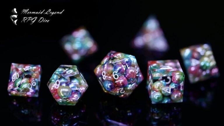 A set of colorful RPG dice with pearl-like inclusions, including a d4, d6, d8, d10, d12, and d20, is artfully displayed on a black surface. These vibrant snippets of gaming magic showcase a stunning mix of red, green, and purple hues—perfect for an unforgettable Friday night gaming session.