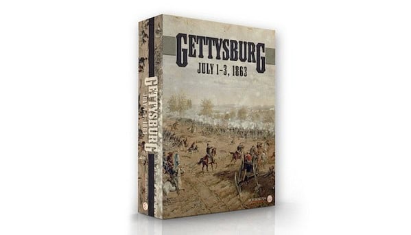 The box cover of "Gettysburg: July 1-3, 1863," a nostalgic nod to Old School Wargames, displays a historical painting of the iconic battlefield with soldiers and cannons under a cloudy sky. The game box is depicted at an angle, highlighting its Kickstarter origins.