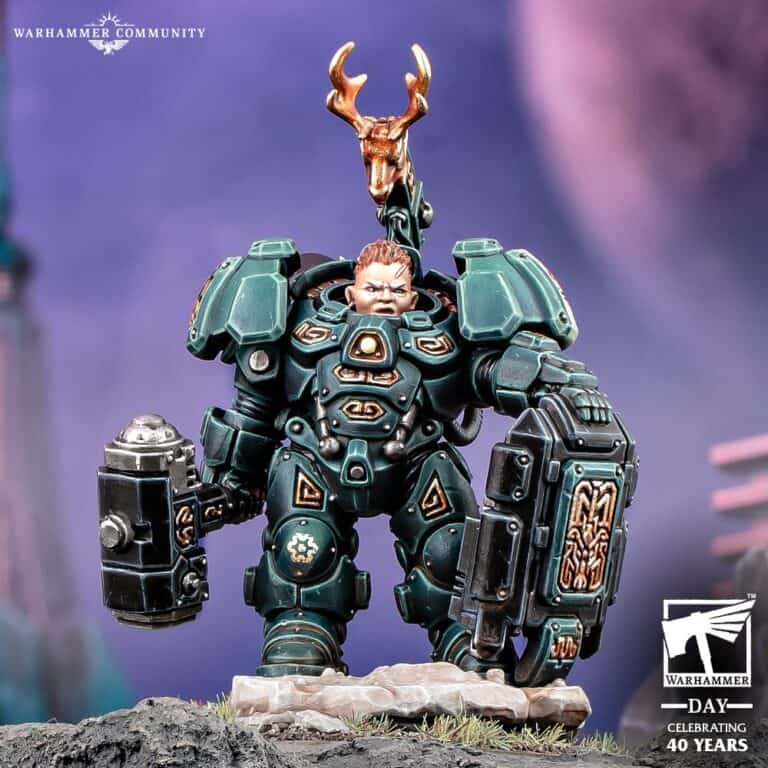 A detailed Warhammer 40K miniature showcases an armored figure with intricate designs, wielding a weapon. The unique helmet adorned with deer antlers stands proudly above. Set against a vibrant, blurred background, this piece celebrates 40 years of Warhammer with the official Warhammer Day badge.