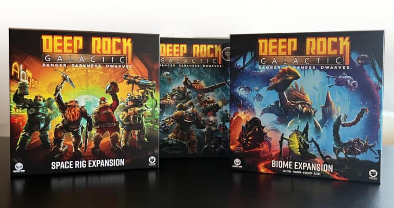 Displayed are three "Deep Rock Galactic" board game boxes: the Space Rig and Biome expansions. The covers showcase vibrant artwork of dwarves in armored suits, set against futuristic landscapes filled with intriguing creatures.