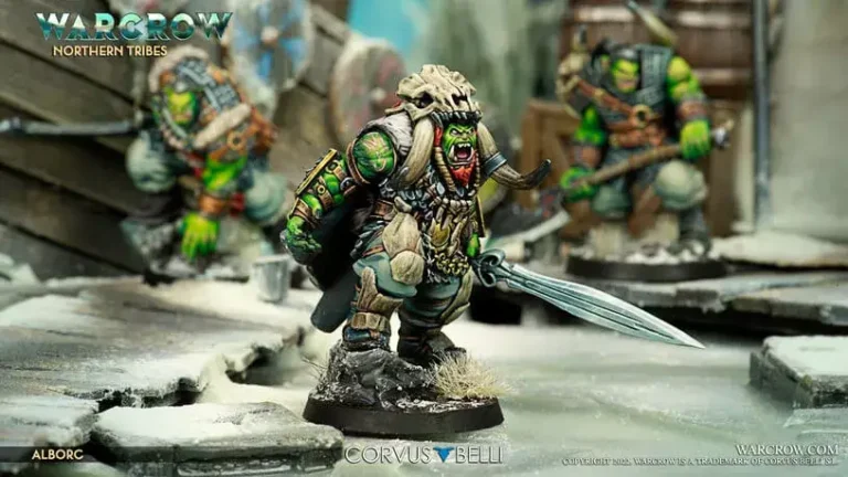 Detailed miniature figurines of orc warriors are on display in this Warcrow Battle Box. The central figure is heavily armored, clutching a large sword, set against a snowy, rugged backdrop. Two other orc figures linger in the background, adding depth to the icy scene.