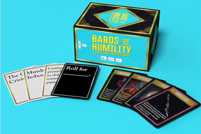 A box of "Bards vs Humility" comedy game cards rests on a blue background. Five cards are fanned out beside it, revealing the fantasy game's quirky theme and whimsical illustrations.