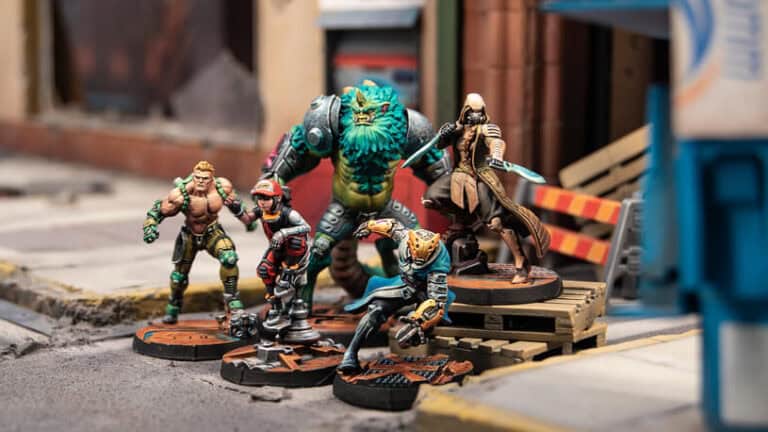 A group of detailed miniature figures, including a humanoid beast, armored warriors, and futuristic soldiers, are posed in an urban setting. This November's new releases delight Infinity players with a street scene featuring construction barriers and a building backdrop.