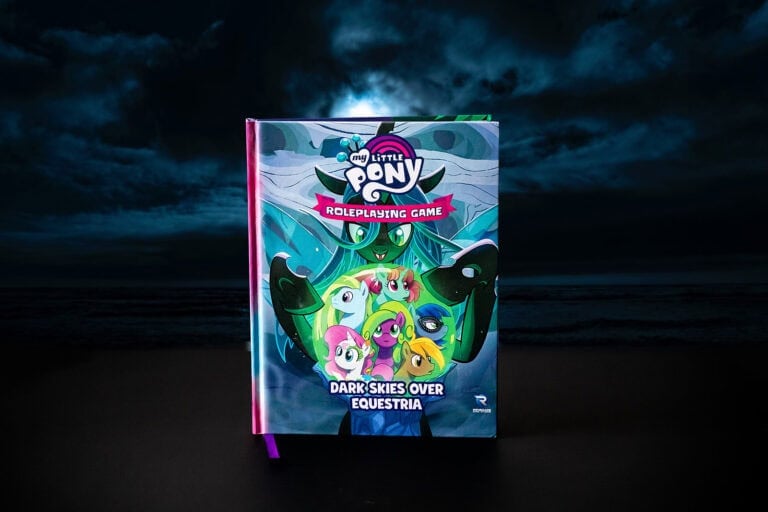 Renegade Game Studios presents the cover of "My Little Pony Roleplaying Game: Dark Skies Over Equestria," showcasing colorful pony characters set against a dark, mystical background, with a looming figure menacingly behind them.