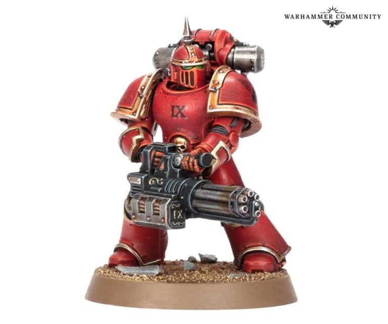 A figure in red and gold power armor, reminiscent of the Blood Angels, stands on a textured base, gripping a futuristic weapon. The armor boasts spikes and intricate embellishments. "Warhammer Community" is visible in the top corner, hinting at a Games Workshop reveal for Heresy Thursday.