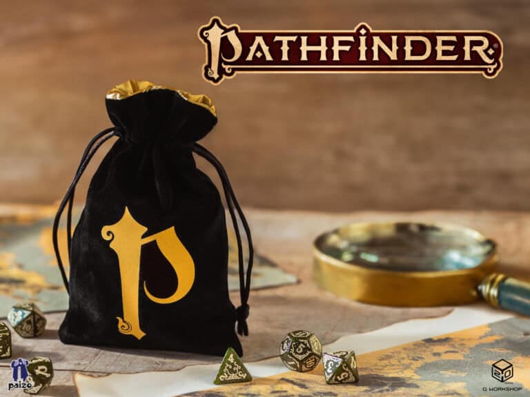 A black velvet bag with a golden "P" rests on a tabletop, paired with Q WORKSHOP polyhedral dice, a map, and a magnifying glass. The iconic "Pathfinder" logo is proudly displayed above.