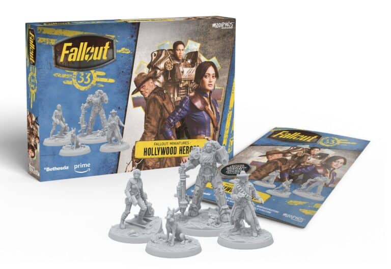 Box set of "Fallout Miniatures: Hollywood Heroes" featuring four gray figurines and a colorful illustrated box and leaflet. The packaging showcases video game-inspired characters, reminiscent of Star Trek's futuristic design, all in dynamic action poses.