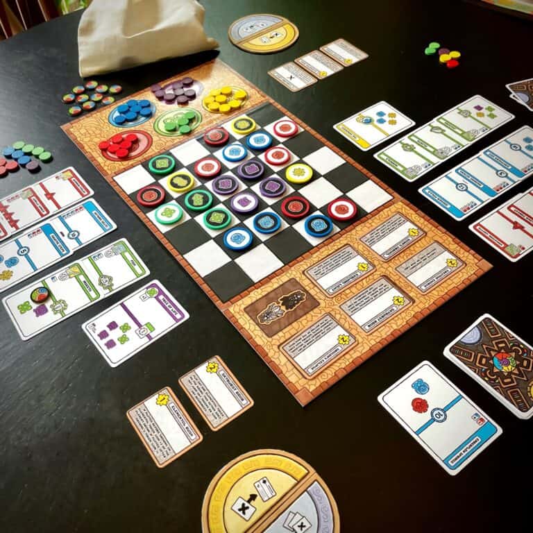 A vibrant strategy board game setup features a checkered board filled with colorful tokens, surrounded by cards and various game pieces on a dark table. A cloth bag and score trackers are visible, hinting at "Children of the Sun," an engaging Kickstarter launch.