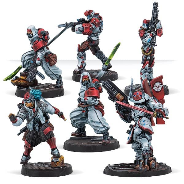 A group of six intricately painted sci-fi miniatures from the Infinity series, featuring futuristic armored warriors, each holding various weapons. The miniatures are posed dynamically with red, white, and gray color schemes, standing on detailed bases reminiscent of Corvus Belli's signature style.