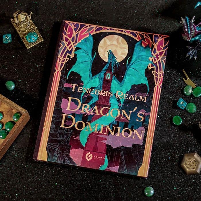 Tenebris Realm: Dragon's Dominion," crafted by Goldleaf Games, showcases a dragon under a full moon. The game is set on a dark, glittery surface surrounded by green dice and figurines, embodying the mysterious allure of Gabrielle Baker's enchanting design.